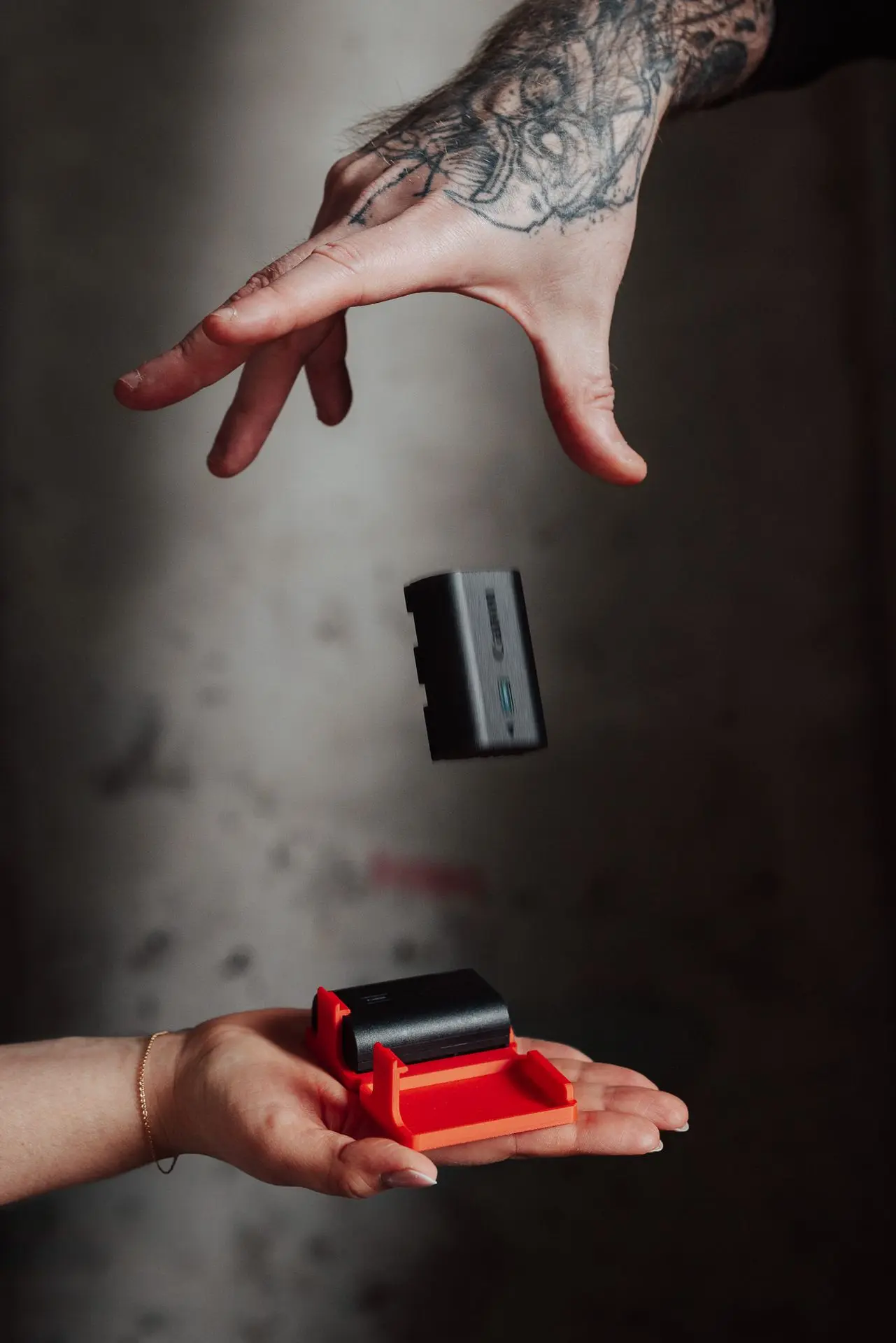 Someone dropping a battery on a 3d printed hōld Duo support
