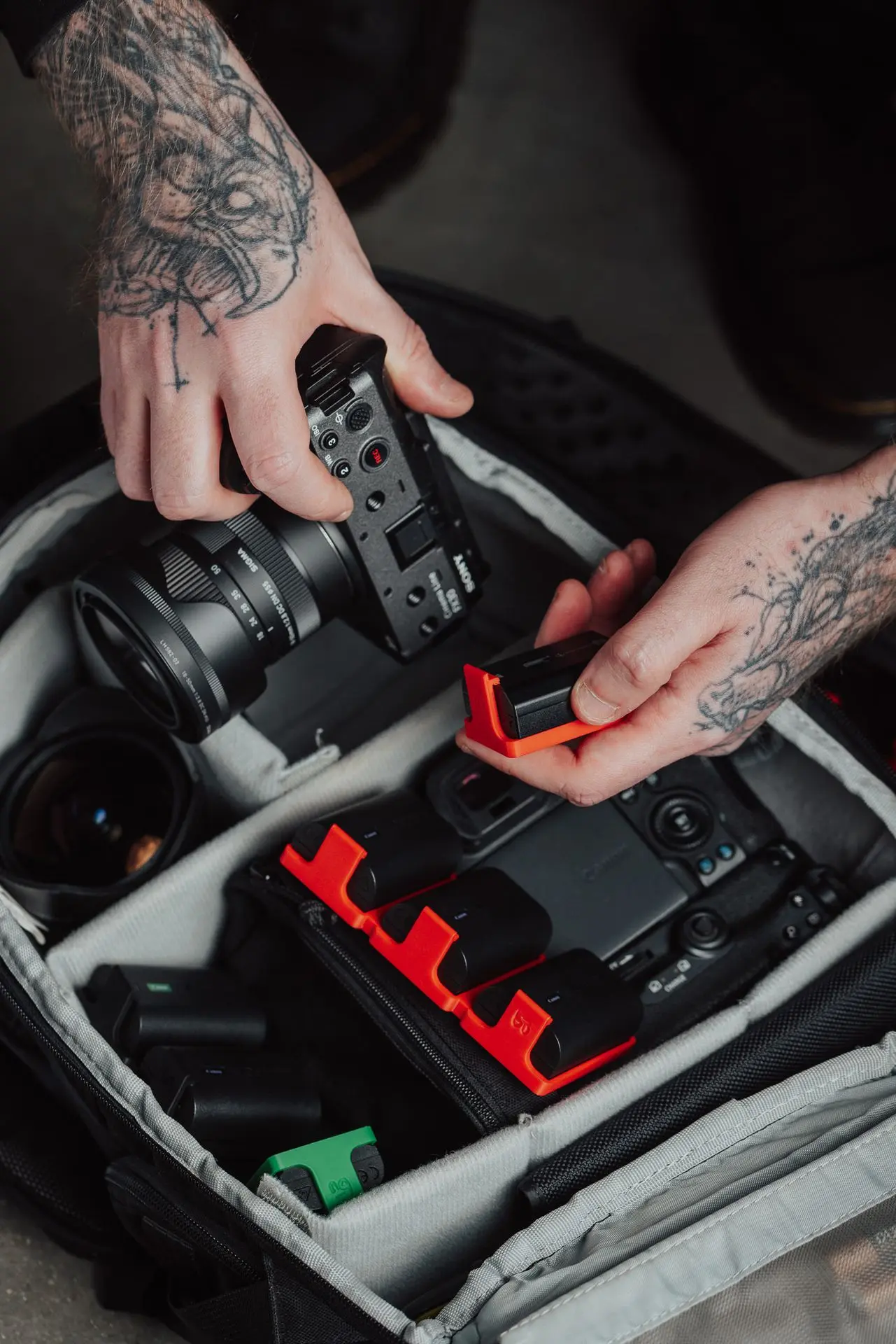 A photo bag full of equipment with a few Hōld family models to help organise the batteries