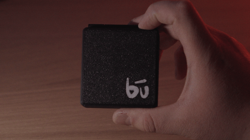 Kōlor in someone's hand, moving slowly to show the textured outer shell.